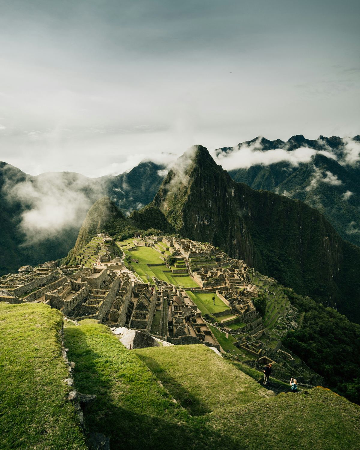 Cloud sitting low across an Andean valley, ridges rising through it.